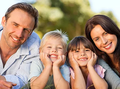 couple smiling with their kids after taking them to Bishop Arts Kids Pediatric Dentistry